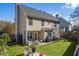 Home's back features a patio, yard, and playset at 215 Mackenzie Ct, Canton, GA 30115