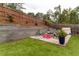 Stone patio with fire pit and seating area at 215 Mackenzie Ct, Canton, GA 30115