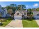 Two-story house with a two-car garage and well-manicured lawn at 215 Mackenzie Ct, Canton, GA 30115
