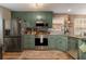 Modern kitchen with stainless steel appliances and green cabinets at 215 Mackenzie Ct, Canton, GA 30115