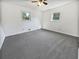 Bright bedroom featuring grey carpet and two windows at 1680 Drakes Dr, Jonesboro, GA 30236