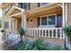 Inviting front porch with a porch swing and ornate railing at 5892 Smoke Rise Ct, Stone Mountain, GA 30087