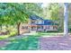 Two-story house with a wraparound porch, situated on a grassy lot at 5892 Smoke Rise Ct, Stone Mountain, GA 30087