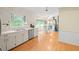 Eat-in kitchen with white cabinets, stainless steel appliances, and hardwood floors at 5892 Smoke Rise Ct, Stone Mountain, GA 30087