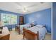 Well-lit bedroom with twin beds and built-in shelving at 5892 Smoke Rise Ct, Stone Mountain, GA 30087