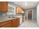 Kitchen with wood cabinets, white appliances, and marble-look flooring at 79 Greystone Way, Hiram, GA 30141