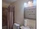 Modern bathroom featuring a toilet, sink, and decorative mirror at 2594 Boulder Springs Pt, Ellenwood, GA 30294