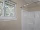 Bathroom with shower, window, and neutral decor at 8060 Northcrest Dr, Jonesboro, GA 30238