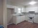 Kitchen with white cabinets and laminate flooring at 8060 Northcrest Dr, Jonesboro, GA 30238