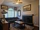 Living room with sectional sofa, fireplace, and large windows at 305 Melton Way, Covington, GA 30016