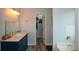 Bathroom with blue vanity, granite countertop, and walk-in closet at 1712 Graystone Dr, Hampton, GA 30228