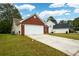 Brick ranch home with attached garage and driveway at 1712 Graystone Dr, Hampton, GA 30228