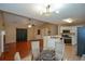 Eat-in kitchen with stainless steel appliances and hardwood floors at 1712 Graystone Dr, Hampton, GA 30228