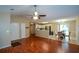 Open concept living area with hardwood floors and kitchen view at 1712 Graystone Dr, Hampton, GA 30228