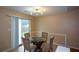 Dining area with glass table and four chairs, near kitchen at 1712 Graystone Dr, Hampton, GA 30228