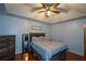 Bright bedroom with ceiling fan and hardwood floors at 1712 Graystone Dr, Hampton, GA 30228