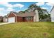 Brick ranch home with attached garage and landscaped lawn at 1712 Graystone Dr, Hampton, GA 30228