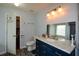 Bathroom with blue vanity, granite countertop, and toilet at 1712 Graystone Dr, Hampton, GA 30228