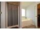 Bathroom with tub, shower, and grey shower curtain at 1712 Graystone Dr, Hampton, GA 30228