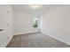 Bright bedroom with carpet flooring and a door at 2126 Seavey Dr, Decatur, GA 30032