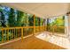 Back deck with wooden railing and view of trees at 2126 Seavey Dr, Decatur, GA 30032