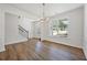 Bright dining room with hardwood floors, chandelier and wainscoting at 2126 Seavey Dr, Decatur, GA 30032