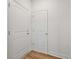 Laundry closet with two white doors and wood flooring at 2126 Seavey Dr, Decatur, GA 30032