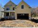 Two-story house with a beige exterior, white columns, and a double-car garage at 3255 Hilltop Cir, Marietta, GA 30066