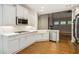 White kitchen cabinets, quartz countertops and a farmhouse sink at 8010 Majors Mill Dr, Cumming, GA 30041