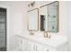 Modern bathroom featuring white double vanity, gold fixtures, and marble-tiled walk-in shower at 600 Jones Rd, Roswell, GA 30075