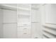 Spacious walk-in closet with built-in shelving, drawers, and hanging rods at 600 Jones Rd, Roswell, GA 30075