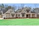 Two-story home with neutral siding, brick accents, and a welcoming front porch at 234 Aberdeen Way, Woodstock, GA 30188