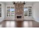 Brick fireplace as a focal point in a sunlit living room at 234 Aberdeen Way, Woodstock, GA 30188
