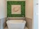 Relaxing bathroom with a freestanding bathtub and a green wall at 976 Memorial Se Walk, Atlanta, GA 30316