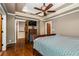 Spacious bedroom with hardwood floors, a dresser and access to upper floor at 2516 Alston Se Dr, Atlanta, GA 30317