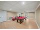 Finished basement recreation room with pool table and ample space for games at 6234 Creekstone Path, Cumming, GA 30041