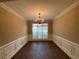 Bright dining room features hardwood floors and elegant chandelier at 112 Edgeview Ct, Dallas, GA 30157