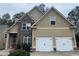 Two-story house with stone accents and a three-car garage at 112 Edgeview Ct, Dallas, GA 30157