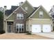 Two-story house with stone accents and a three-car garage at 112 Edgeview Ct, Dallas, GA 30157