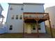 Elevated deck and patio with stairs leading to the backyard at 573 Auburn Crossing Dr, Auburn, GA 30011