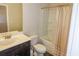Bathroom with tub, toilet and tan shower curtain at 573 Auburn Crossing Dr, Auburn, GA 30011