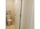Small half bathroom with toilet and neutral color palette at 573 Auburn Crossing Dr, Auburn, GA 30011