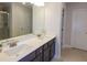 Modern bathroom with double sinks, dark cabinets, and a quartz countertop at 573 Auburn Crossing Dr, Auburn, GA 30011