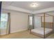 Spacious bedroom with carpeted floor, large windows, and a four-poster bed at 573 Auburn Crossing Dr, Auburn, GA 30011