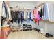 Walk-in closet with ample shelving and hanging space for clothes and shoes at 573 Auburn Crossing Dr, Auburn, GA 30011