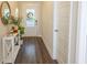 Bright entryway with hardwood floors, console table, and mirror at 573 Auburn Crossing Dr, Auburn, GA 30011