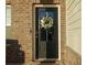 Modern dark-stained front door accented with a wreath at 573 Auburn Crossing Dr, Auburn, GA 30011
