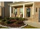 Brick front porch with seating area and landscaping at 573 Auburn Crossing Dr, Auburn, GA 30011