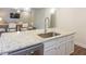 Kitchen island with granite countertop and stainless steel sink at 573 Auburn Crossing Dr, Auburn, GA 30011