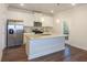 Modern kitchen with island, stainless steel appliances, and granite countertops at 573 Auburn Crossing Dr, Auburn, GA 30011